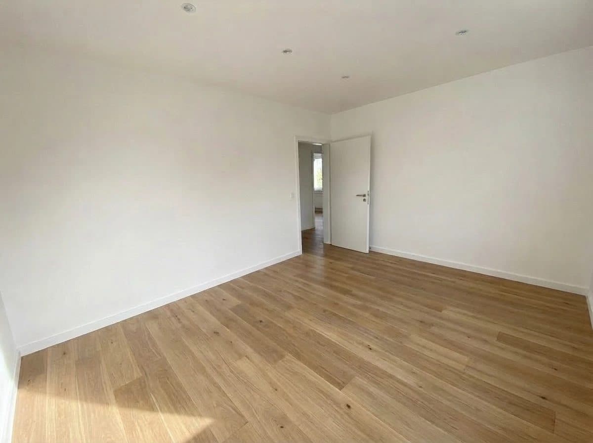 Wohnung 1: Zimmer mit Blick durch die Tür in die Diele